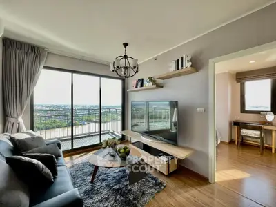 Modern living room with large window and scenic view, stylish decor and cozy ambiance.