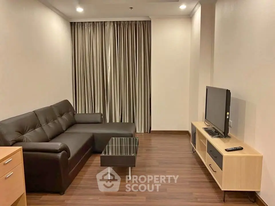 Modern living room with sleek furniture and wooden flooring in a cozy apartment.