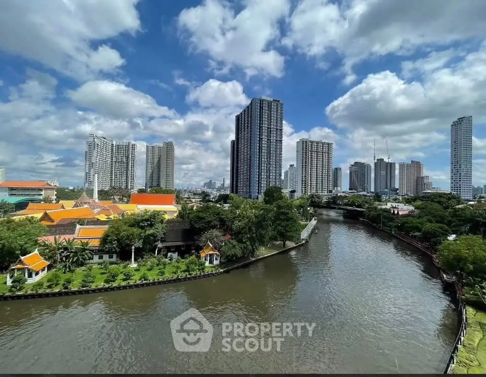 Stunning cityscape view with modern high-rise buildings and serene river, perfect for urban living.