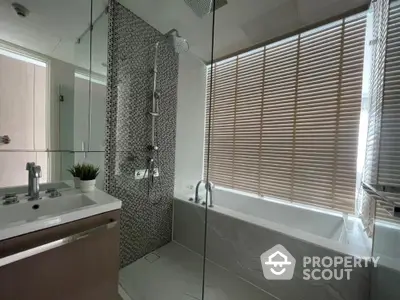 Modern bathroom with sleek design, featuring a bathtub and stylish fixtures, perfect for relaxation.