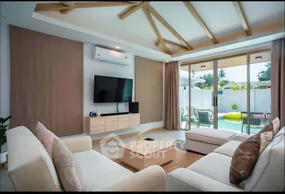 Luxurious living room with modern decor and pool view, perfect for relaxation and entertainment.