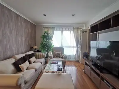 Charming living room with cozy seating and natural light, perfect for relaxation and entertainment.