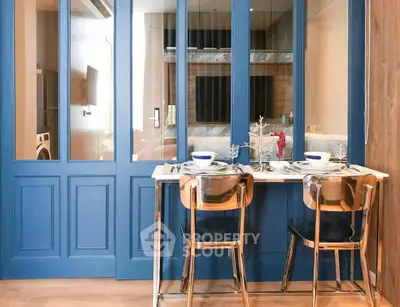 Stylish dining area with modern decor and blue accents in a contemporary apartment.