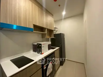 Modern kitchen with sleek cabinets and appliances in compact layout