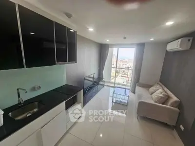 Modern living room with sleek kitchen and city view, featuring minimalist design and ample natural light.