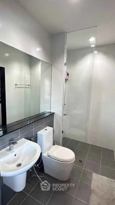 Modern bathroom with sleek fixtures and glass shower enclosure