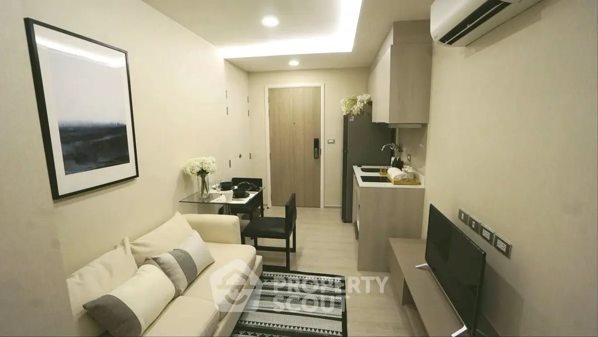 Modern compact living room with integrated kitchen in stylish apartment