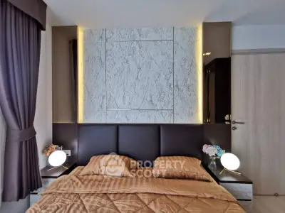 Luxurious bedroom with elegant marble accent wall and modern lighting