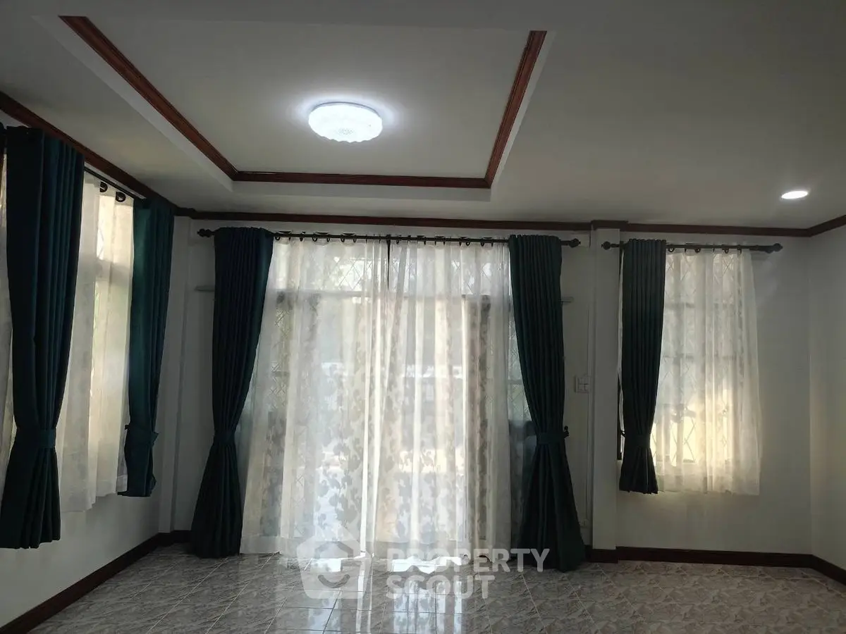 Spacious living room with elegant curtains and natural light