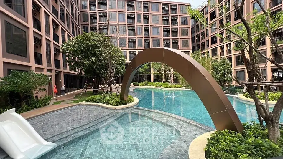 Luxurious apartment complex with stunning pool and lush greenery