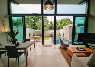 Luxurious living room with pool view and modern decor