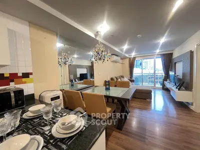 Spacious modern living room with open kitchen and balcony view in luxury apartment.