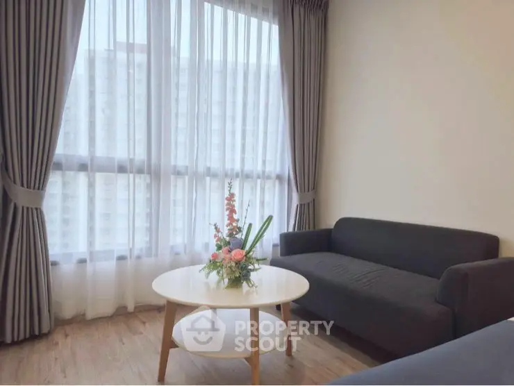 Cozy living room with modern sofa and elegant curtains, perfect for relaxation.