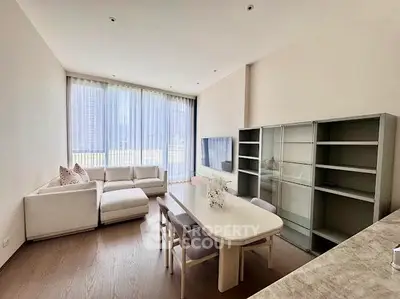 Spacious modern living room with large windows and elegant furniture