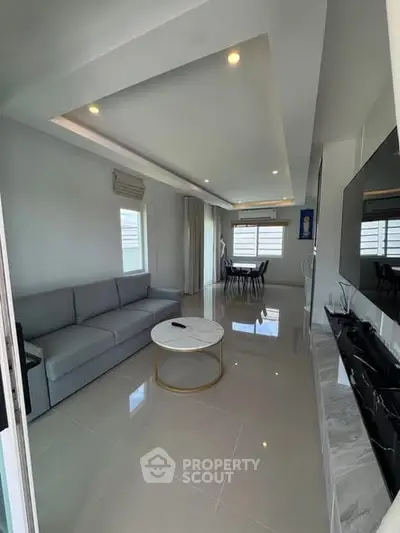 Modern living room with sleek design and ample natural light