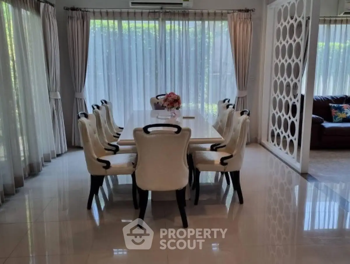 Elegant dining room with large table and stylish chairs, perfect for gatherings.