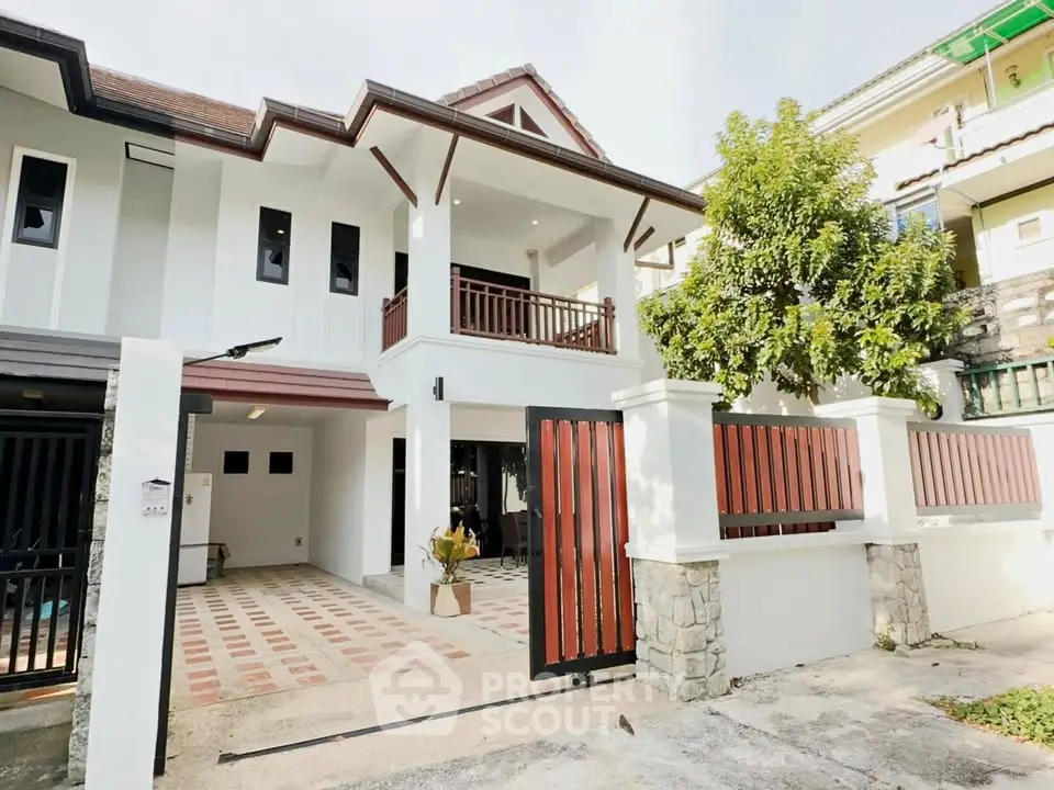 Charming two-story house with spacious balcony and modern exterior design in a serene neighborhood.
