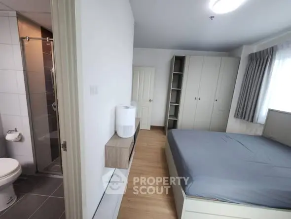 Modern bedroom with ensuite bathroom and ample storage space