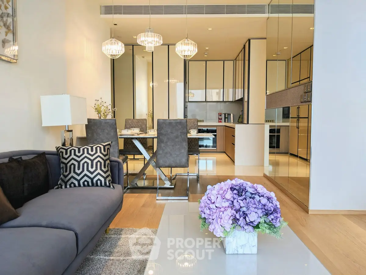 Luxurious modern living room with open kitchen, elegant decor, and stylish lighting in a high-end apartment.