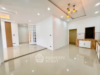 Spacious modern living room with elegant lighting and open layout, perfect for contemporary living.