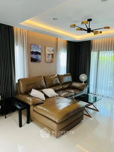 Luxurious living room with leather sectional sofa and modern lighting