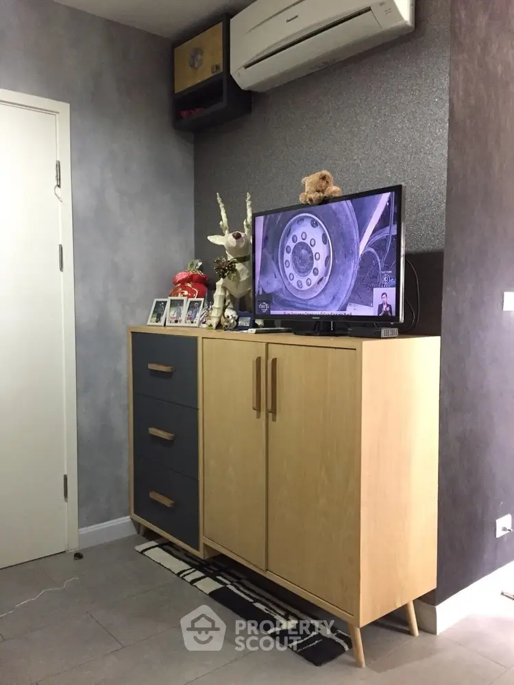 Modern living room with stylish cabinet and wall-mounted air conditioner