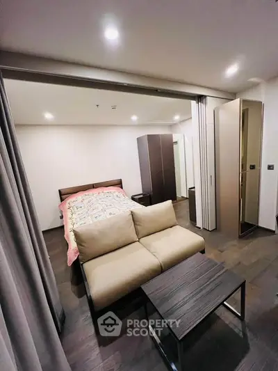 Modern bedroom with cozy sofa and stylish decor in a compact space