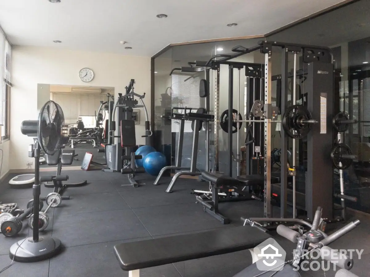 Spacious modern gym with state-of-the-art fitness equipment and ample natural light.