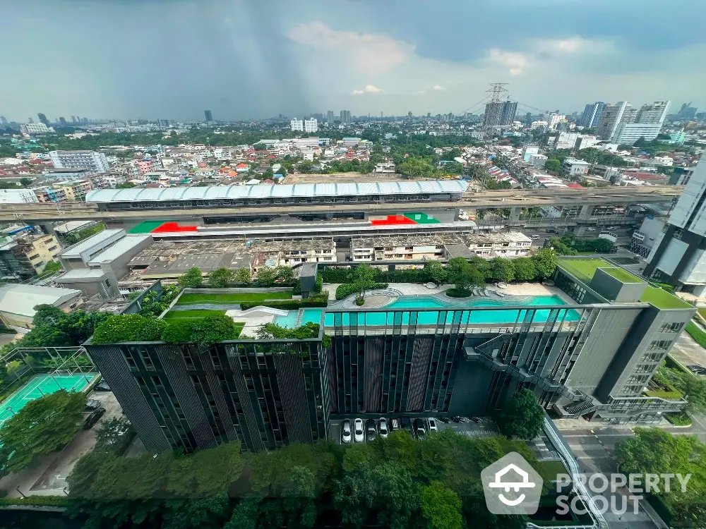 Stunning cityscape view from high-rise building with rooftop pool and lush greenery