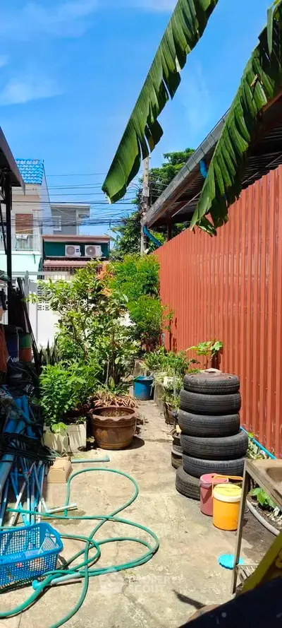 Charming garden area with lush greenery and vibrant plants, perfect for outdoor relaxation.