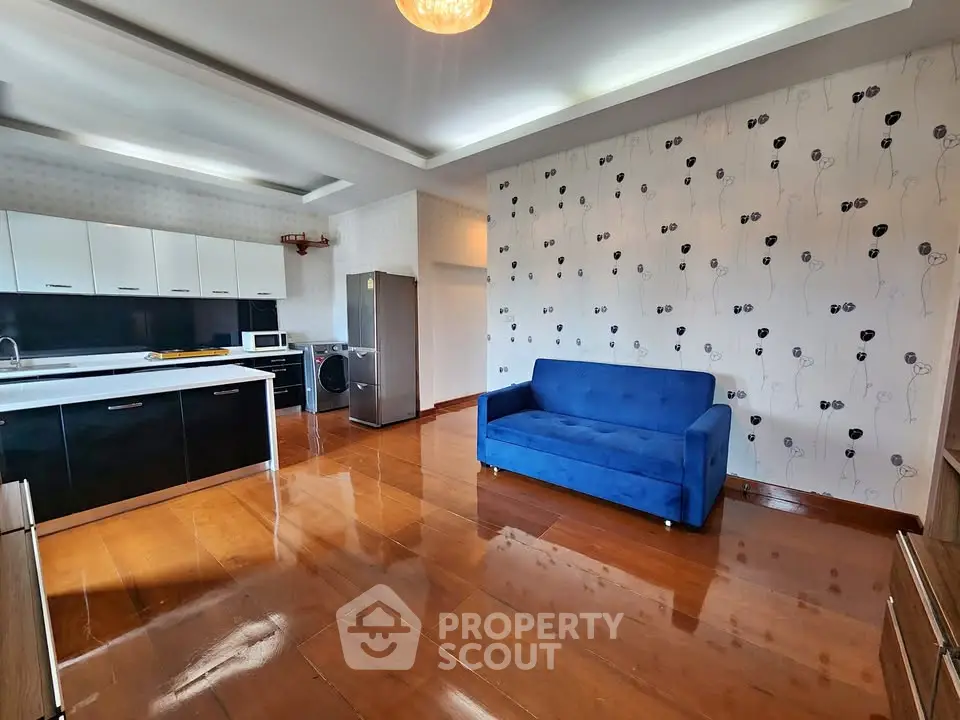 Spacious modern living room with sleek kitchen and stylish decor