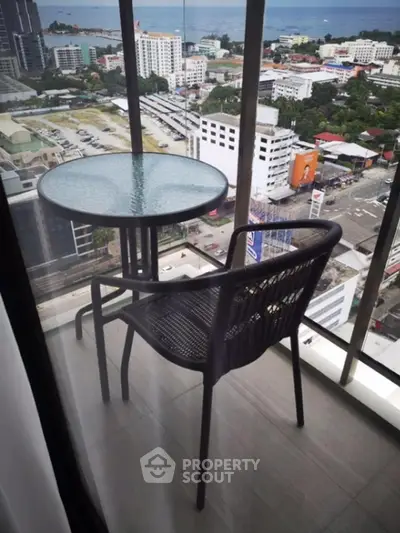 Stunning high-rise balcony with city and ocean view, perfect for relaxation and enjoying the skyline.