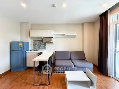 Modern open-plan living room with kitchenette and stylish decor