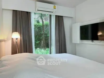 Cozy bedroom with garden view and modern amenities