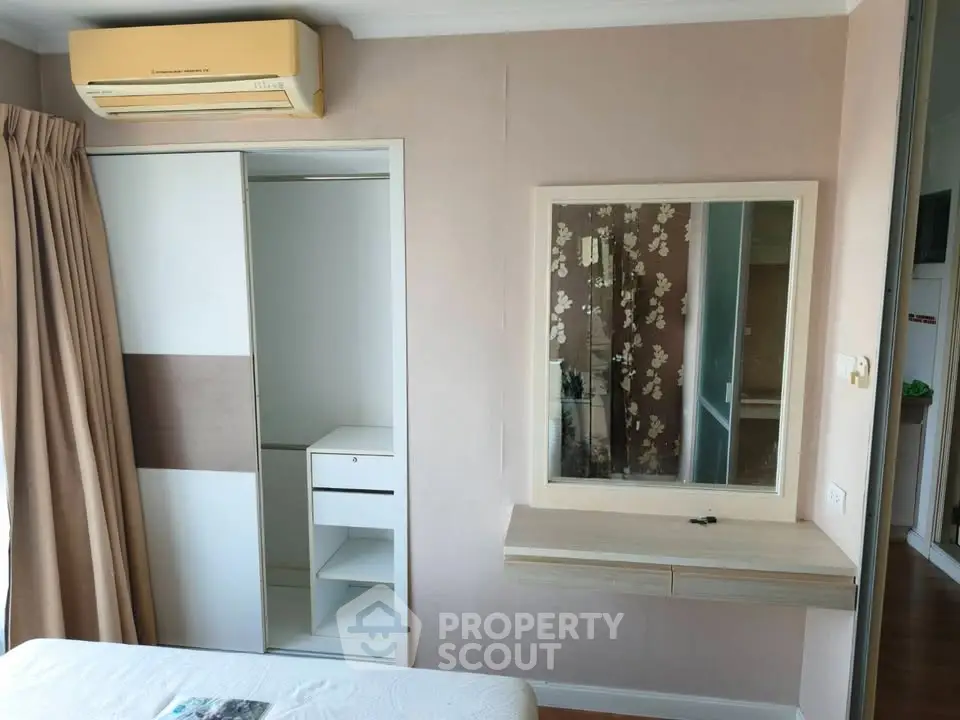 Cozy bedroom with built-in wardrobe and air conditioning, perfect for modern living.