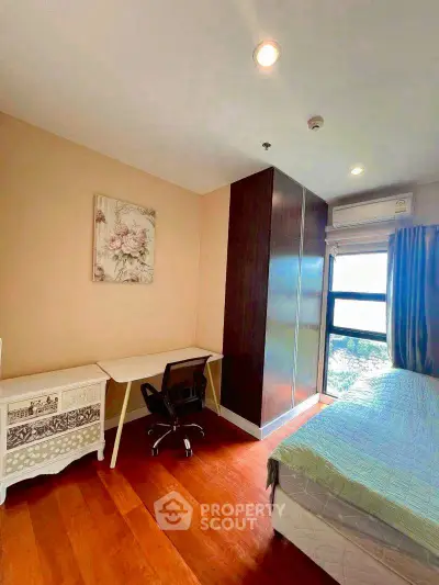 Cozy bedroom with study area and scenic window view, perfect for relaxation and productivity.