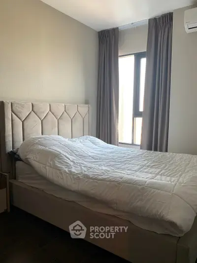 Cozy bedroom with modern bed and large window for natural light