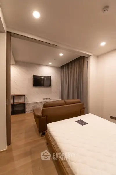 Modern studio apartment with cozy living area and sleek furnishings