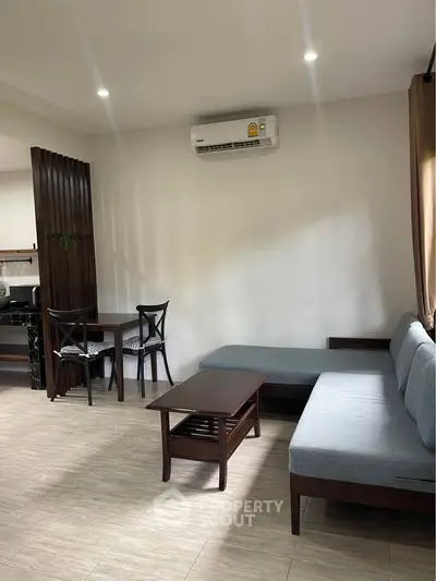 Modern living room with sleek furniture and air conditioning in a cozy apartment.