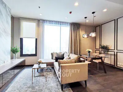 Luxurious modern living room with elegant decor and large windows offering city views.