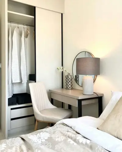 Elegant bedroom with stylish vanity and open closet, perfect for modern living.