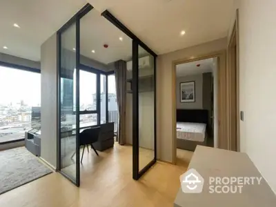 Modern apartment with glass partition, city view, and stylish interior design.