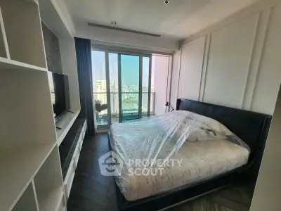 Modern bedroom with large window and city view, featuring sleek design and natural light.
