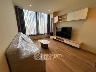Modern living room with sleek furniture and large windows