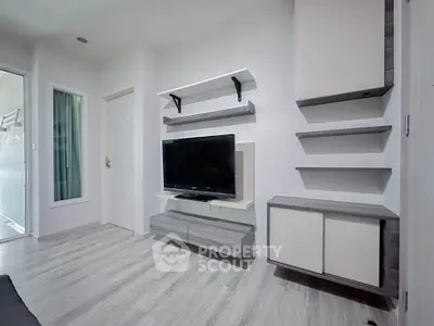 Modern living room with sleek TV unit and minimalist shelving