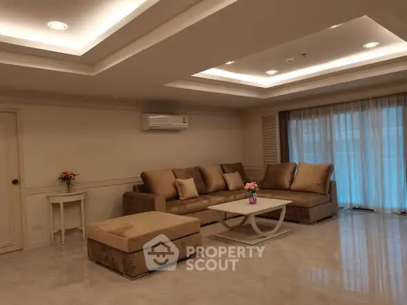 Luxurious living room with elegant ceiling lights and plush furniture in a modern apartment.