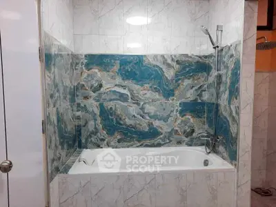 Luxurious bathroom with elegant marble tiles and modern bathtub