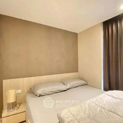 Cozy bedroom with modern decor and soft lighting, perfect for relaxation.