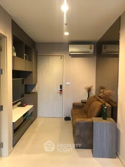 Modern living room with stylish decor and air conditioning in a cozy apartment.