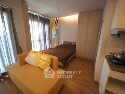 Modern bedroom with cozy sofa and stylish decor in a contemporary apartment.
